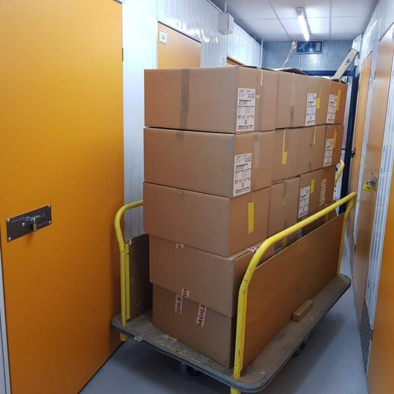 there are packed boxes of stuff placed in a trolley in the storage section